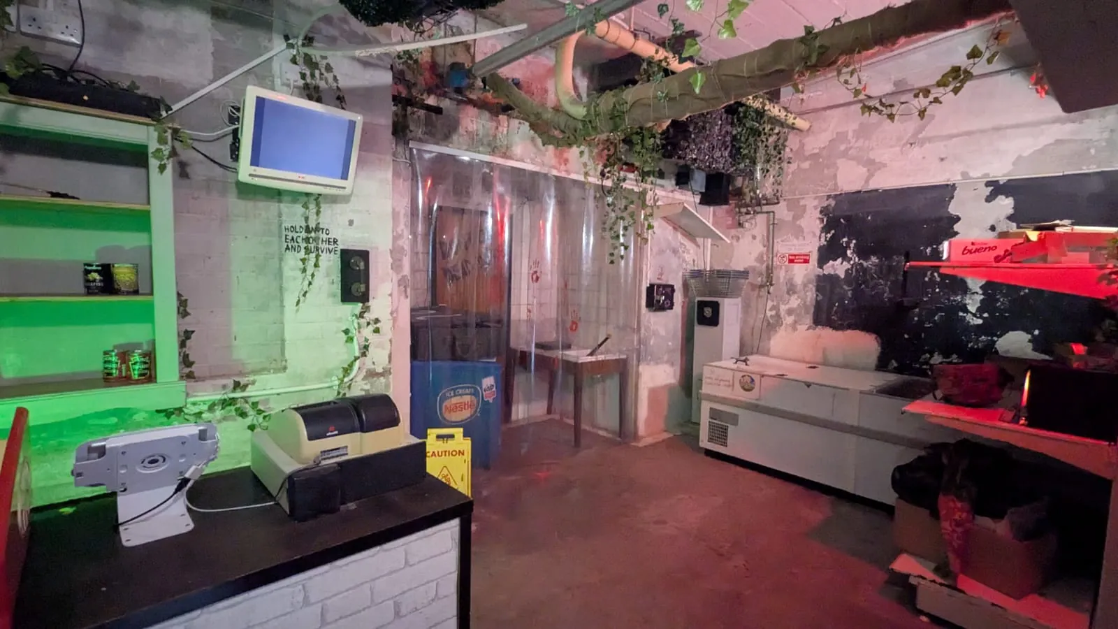 Inside 28 Pasties Later, a zombie escape room in Penzance: the factory set, lit green and red